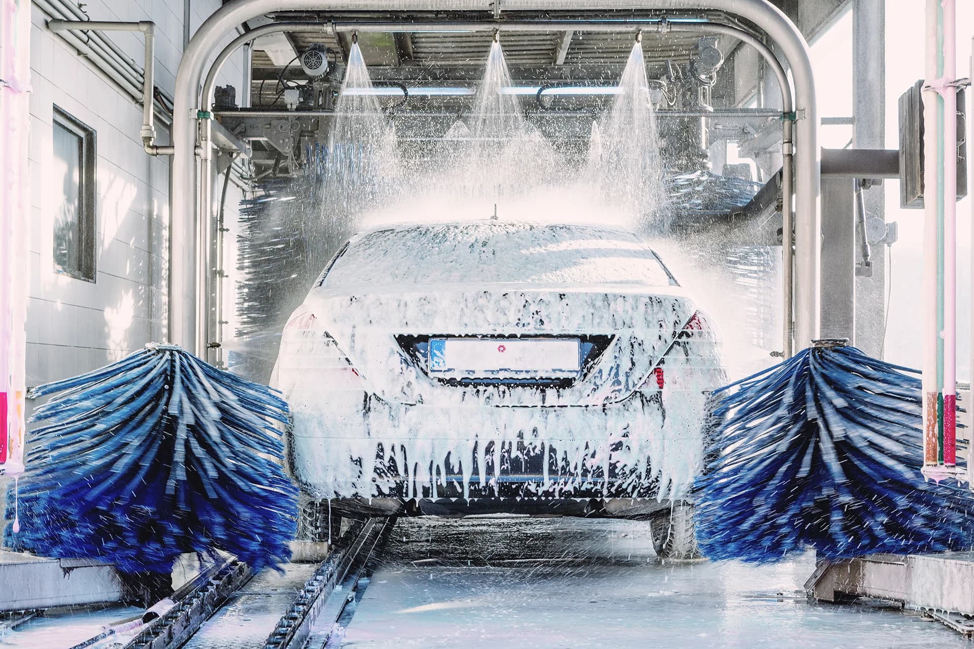 Vehicle moving through an automatic car wash